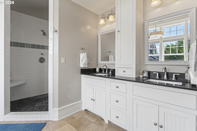 bathroom with vanity, tile patterned floors, and tiled shower