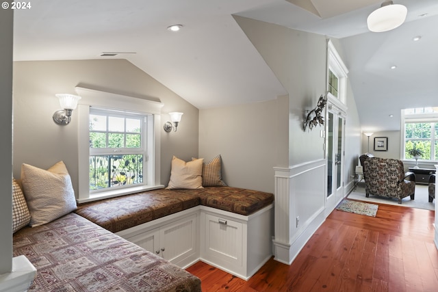 sitting room with a healthy amount of sunlight, wood-type flooring, and lofted ceiling