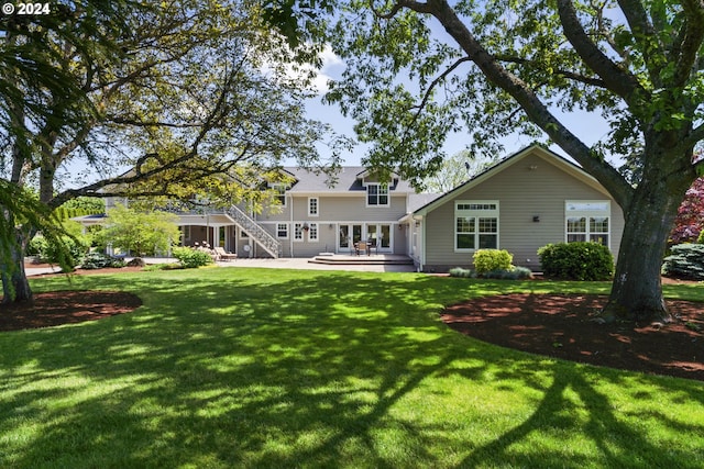 back of house with a wooden deck and a yard