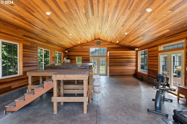 dining room with french doors, wood walls, wooden ceiling, and lofted ceiling