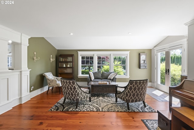 living room featuring french doors, hardwood / wood-style flooring, a healthy amount of sunlight, and vaulted ceiling