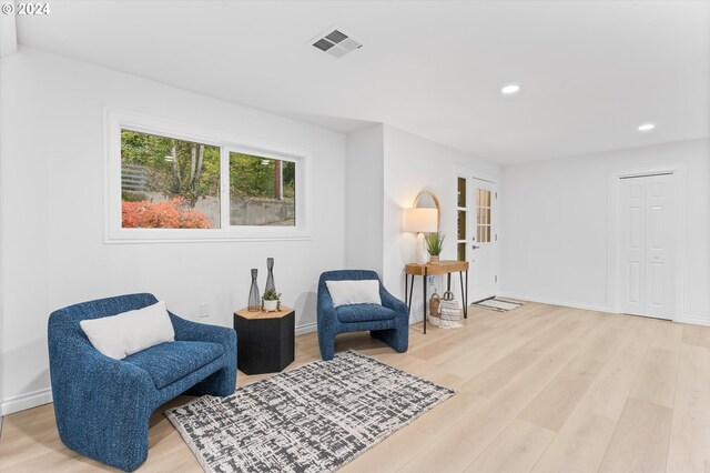 living room featuring french doors and light wood-type flooring