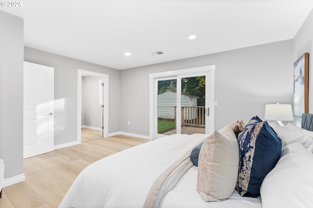 bedroom with access to exterior and light hardwood / wood-style flooring