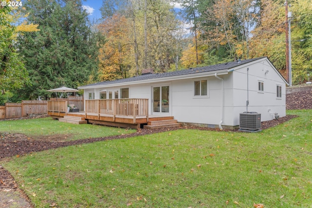 back of house with a deck, central AC unit, and a lawn