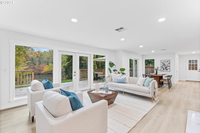 living room with french doors and light hardwood / wood-style floors