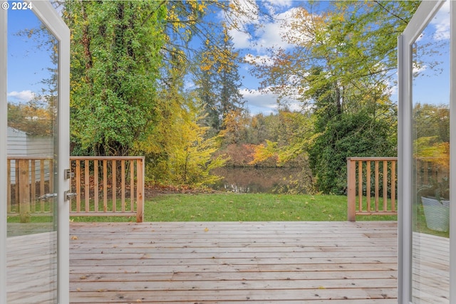 wooden terrace with a lawn