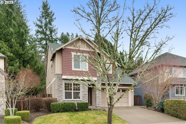 craftsman-style home with fence, a garage, stone siding, driveway, and a front lawn