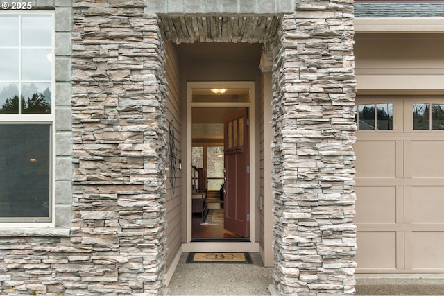 doorway to property with a garage