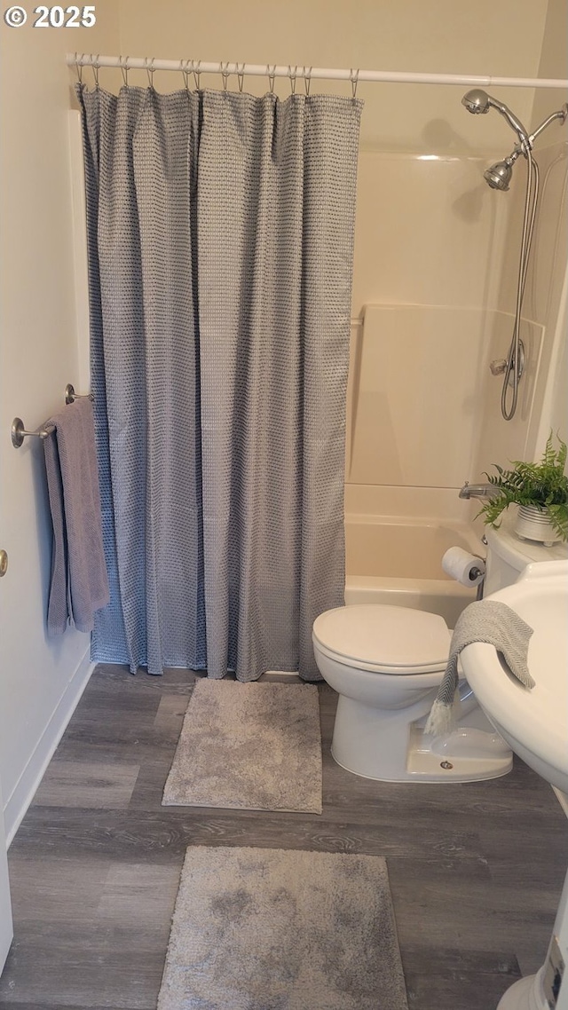 full bath with toilet, shower / bath combo with shower curtain, and wood finished floors