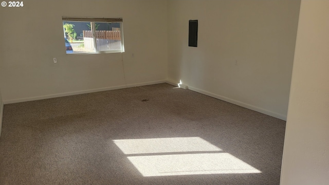 carpeted empty room with baseboards