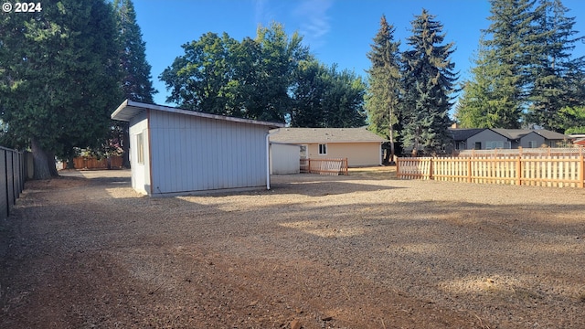 view of yard with an outbuilding and a fenced backyard