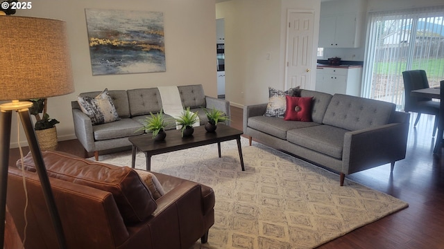 living room featuring baseboards and wood finished floors