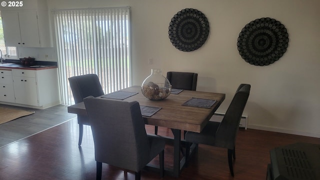 dining area with dark wood finished floors and baseboards