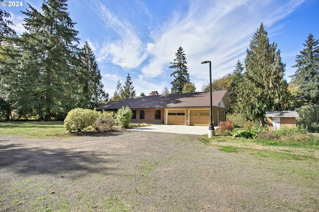 ranch-style home featuring a garage and a front yard