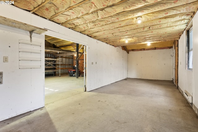 unfinished below grade area with a baseboard radiator