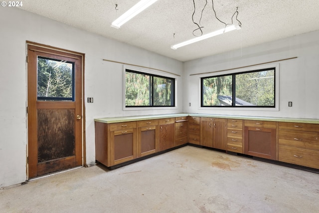 kitchen with a textured ceiling and a wealth of natural light