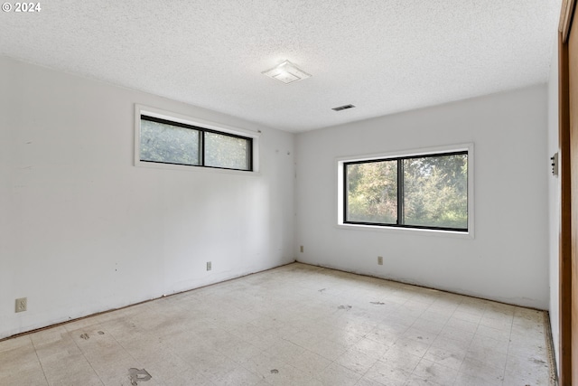 empty room featuring a textured ceiling