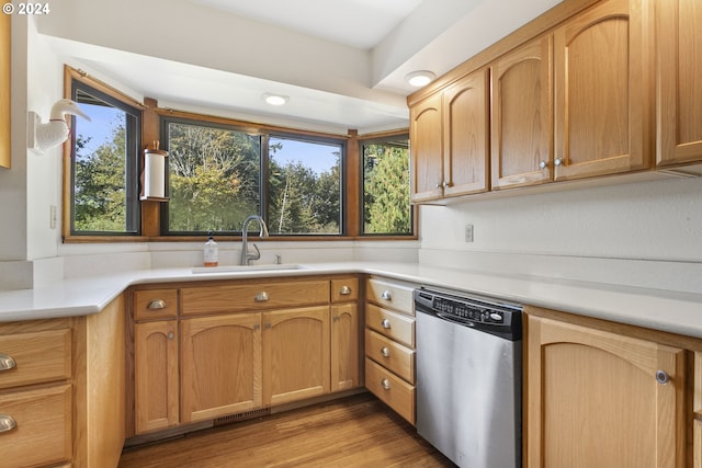 kitchen with sink, plenty of natural light, light hardwood / wood-style floors, and stainless steel dishwasher