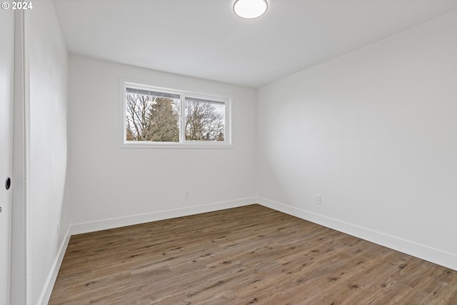 unfurnished room featuring hardwood / wood-style flooring