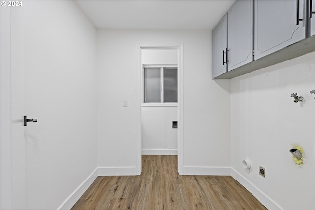 laundry area with cabinets, hookup for a washing machine, light hardwood / wood-style floors, and hookup for an electric dryer