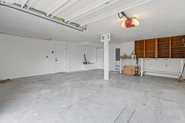 garage with electric panel and a garage door opener