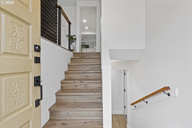 staircase with hardwood / wood-style flooring