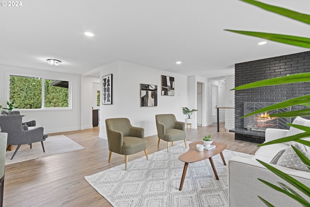 living room featuring a fireplace and light hardwood / wood-style flooring