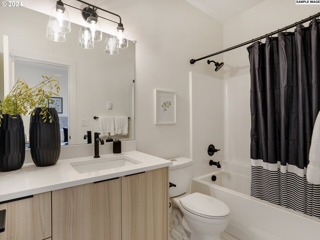 full bathroom featuring vanity, shower / bath combo, and toilet