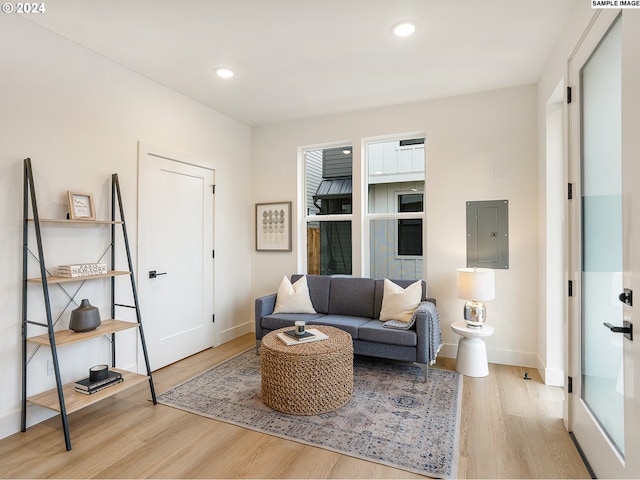 living room with electric panel and light wood-type flooring