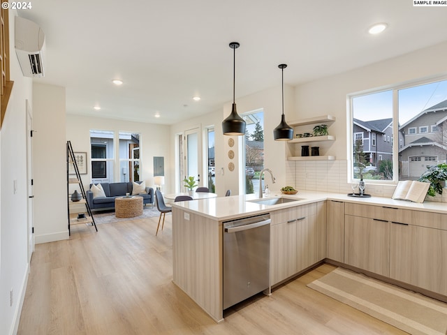 kitchen featuring decorative backsplash, light brown cabinets, sink, dishwasher, and light hardwood / wood-style floors