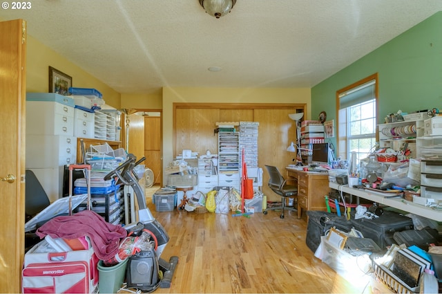 home office with hardwood / wood-style floors and a textured ceiling