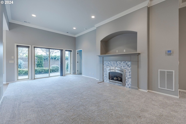 unfurnished living room with a tiled fireplace, light carpet, and ornamental molding