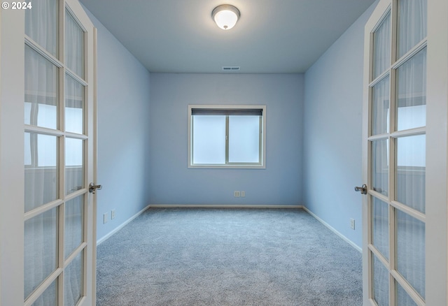 carpeted empty room with french doors