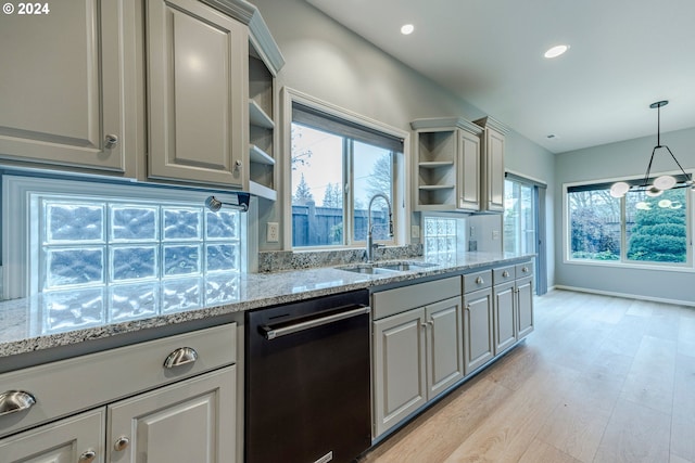 kitchen with gray cabinetry, dishwasher, sink, light hardwood / wood-style flooring, and light stone countertops