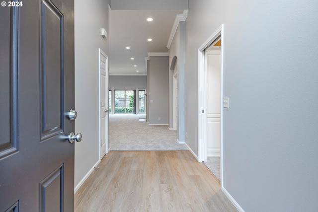 hall featuring crown molding and light hardwood / wood-style flooring