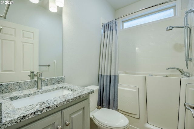 full bathroom featuring vanity, shower / bath combo, and toilet