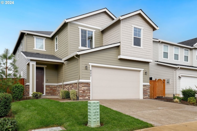 craftsman inspired home featuring a front yard and a garage