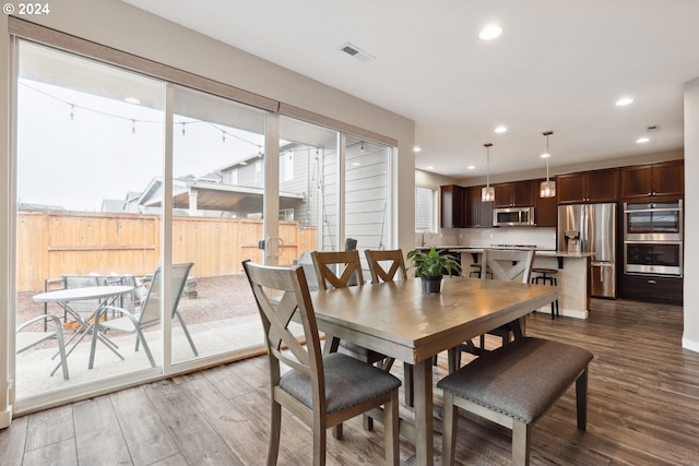 dining space featuring dark hardwood / wood-style floors and sink