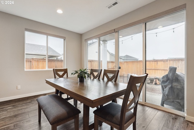 dining space with dark wood-type flooring