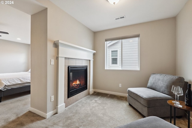 sitting room featuring light carpet and a fireplace