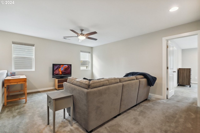 living room with ceiling fan and light colored carpet