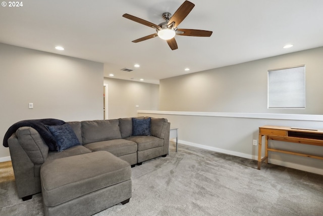 carpeted living room with ceiling fan