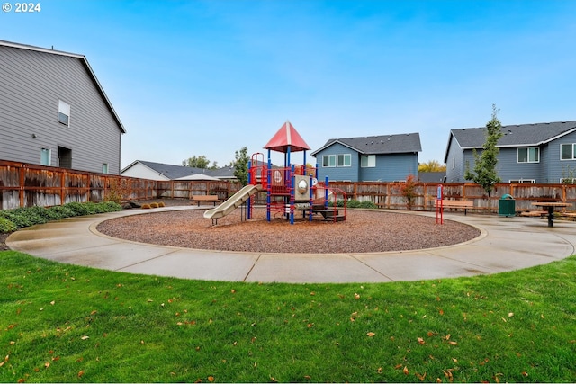 view of jungle gym featuring a lawn