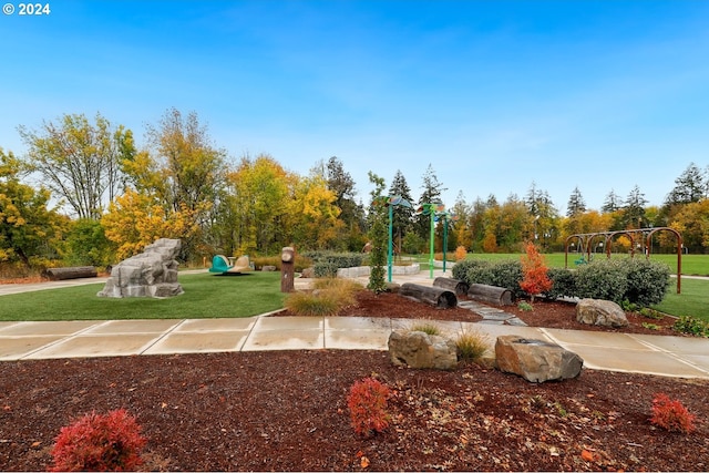 view of property's community with a playground and a yard