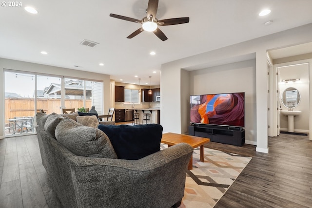 living room featuring ceiling fan and wood-type flooring