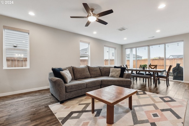 living room with ceiling fan and light hardwood / wood-style flooring