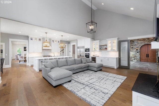 living room featuring hardwood / wood-style floors and high vaulted ceiling