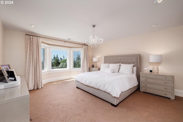 carpeted bedroom with a notable chandelier