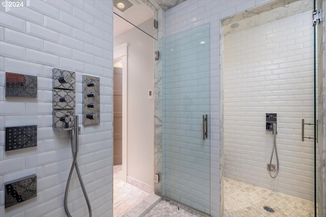 bathroom with a shower with shower door