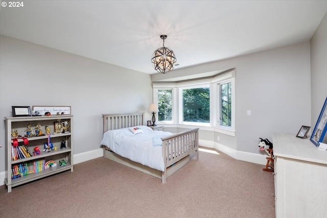 bedroom with carpet flooring and a notable chandelier